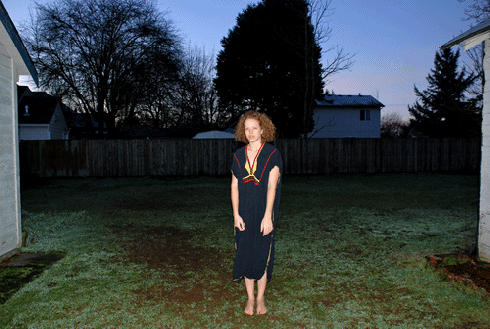 woman standing in a dead pan garden